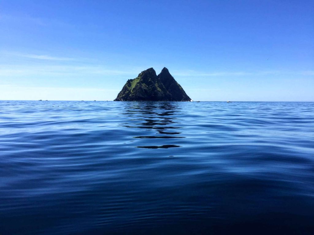 Skellig Michael seen across a calm sea